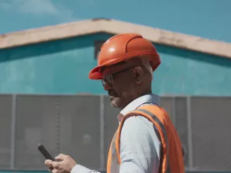man-with-hardhat-on-mobile