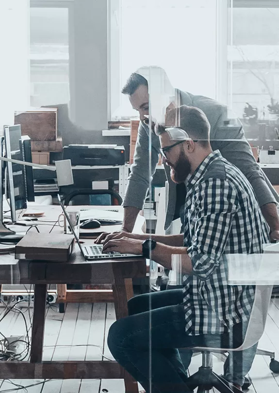 People working at desks and stood around desks